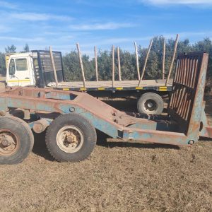 Walking beam timber tip trailer